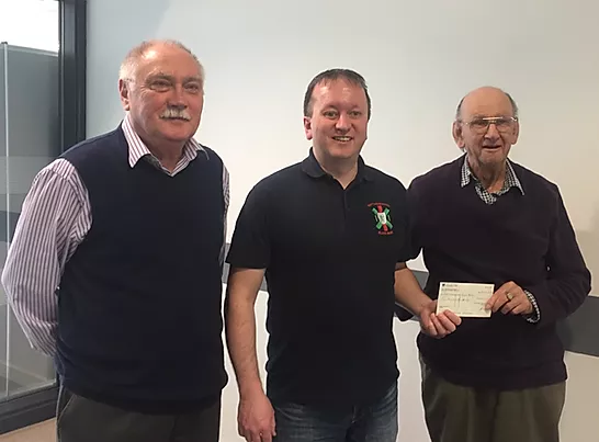 Macmillan recieving a cheque